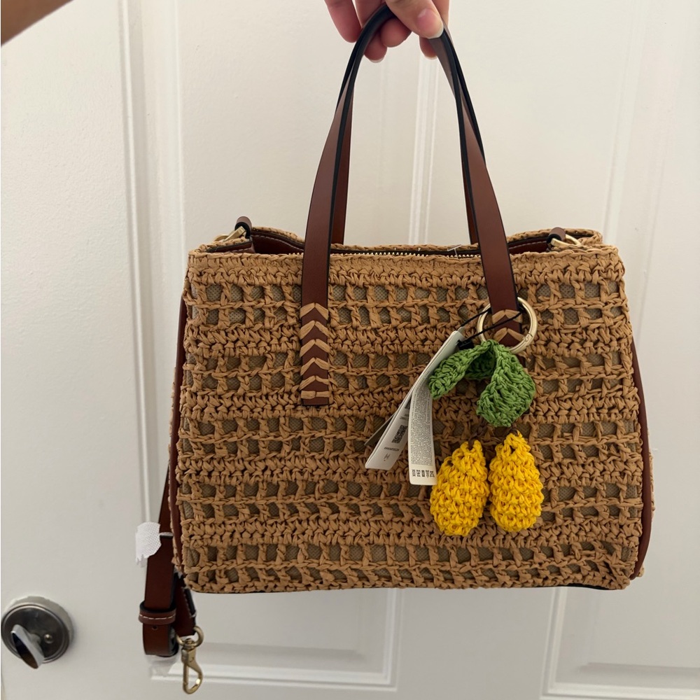 Handwoven Straw Tote with Brown Leather Handles and Yellow Crochet Charm